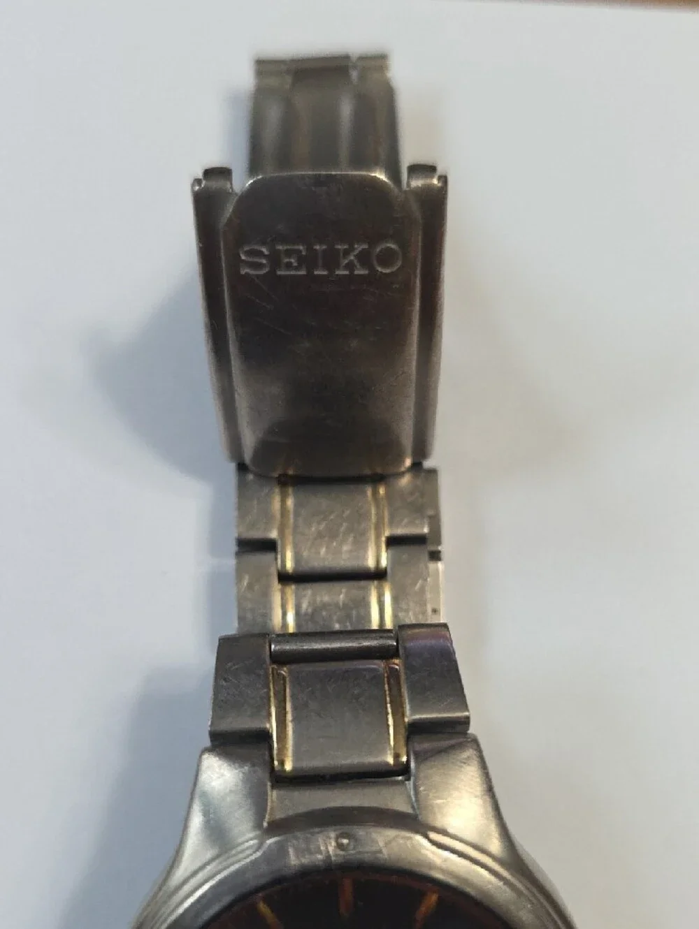 Seiko Titanium Watch with Black Dial and Gold Accents